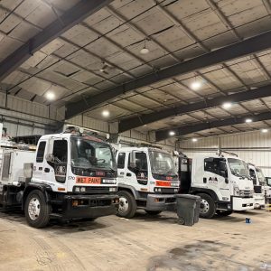 white work trucks in a large garage