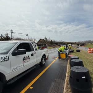 workers installing crash attenuator on interstate