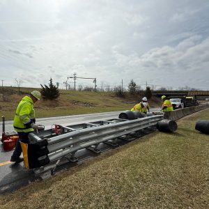 workers installing crash attenuator on interstate